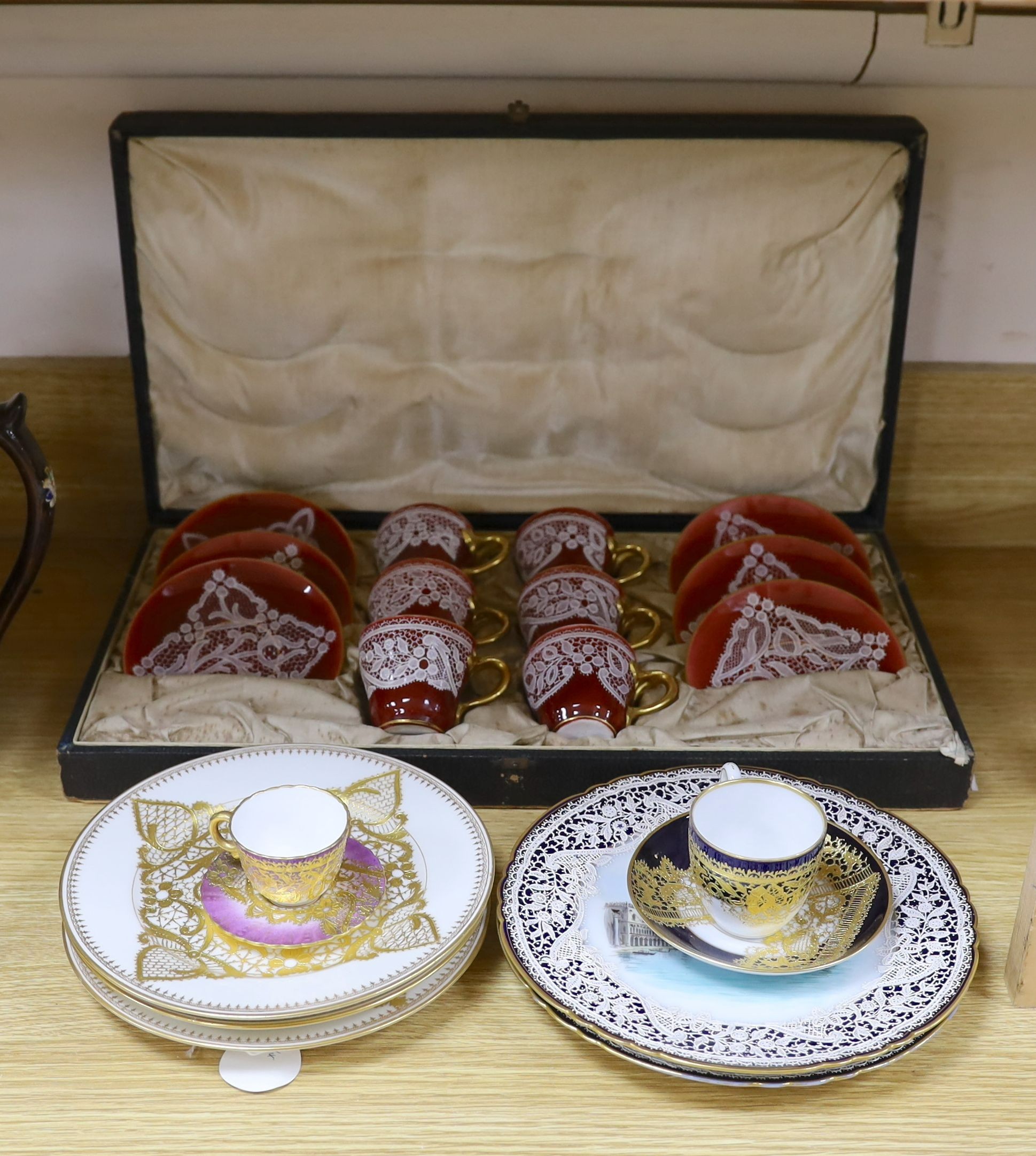 Venetian decorated Lace-pattern ceramics including a cased coffee set and a pair of plates painted with named views of Venice